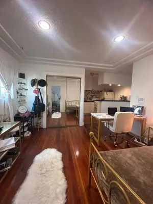 a living room with a desk and a room with a rug at Cozy Studio In West Hollywood in Los Angeles