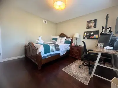 a bedroom with a bed and a desk with a computer at villa Double Room in Chino Hills