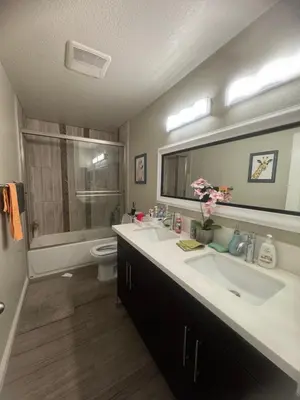 a bathroom with two sinks and a toilet at villa Double Room in Chino Hills