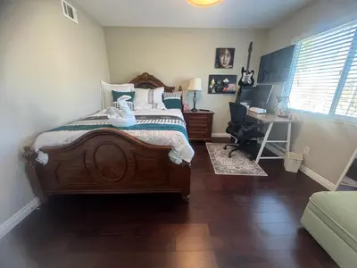 a bedroom with a bed and a desk with a computer at villa Double Room in Chino Hills