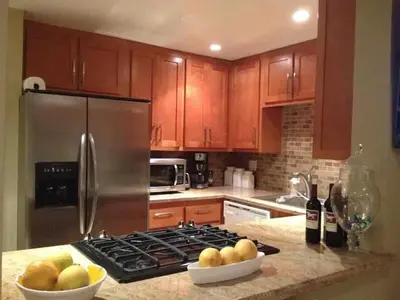 a kitchen with a stove and a bowl of fruit on a counter at 90210 Beach House Middle Unit in Hermosa Beach