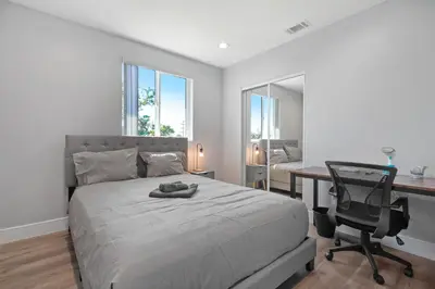 a bedroom with a bed and a desk and a chair at Modern Bedroom in Los Angeles