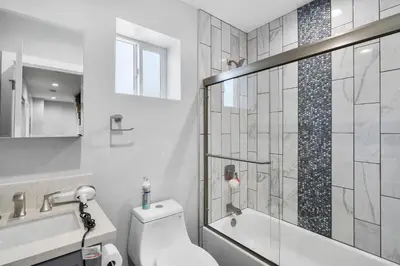 a bathroom with a toilet and a glass shower at Modern Bedroom in Los Angeles