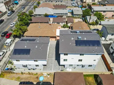 an overhead view of roofs of houses with solar panels at Modern Bedroom in Los Angeles