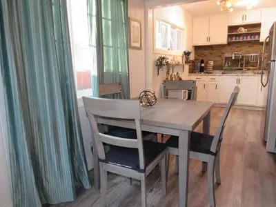 a dining room table and chairs in a kitchen at Forest Moon Cottage in Big Bear City Airport