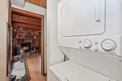 a kitchen with a stove and a fireplace at The Mountain Treehouse, Jacuzzi Large Backyard! in Big Bear Lake