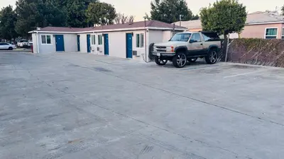 a white truck parked in a parking lot at vogue motel in South Gate