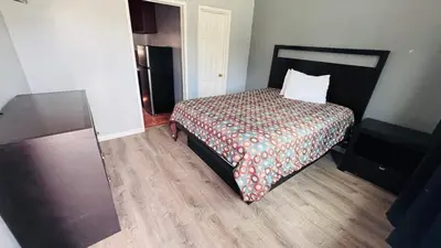 a hotel room with a bed with a pillow on it at vogue motel in South Gate