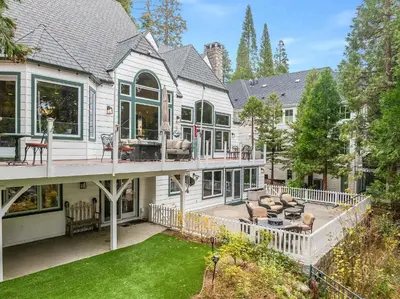 an exterior view of a house with a deck at Navigate Stays Best Dressed Lakefront Home in Lake Arrowhead