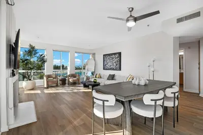 a kitchen and living room with a table and chairs at Coastal Bliss - Luxe 2BR Retreat in MDR - Venice - SM in Los Angeles
