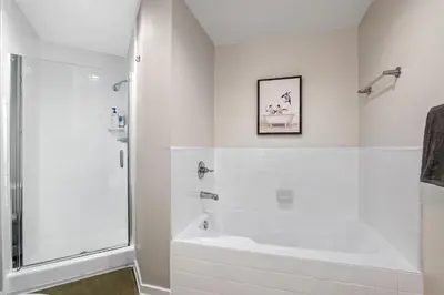 a white bathroom with a shower and a tub at Coastal Bliss - Luxe 2BR Retreat in MDR - Venice - SM in Los Angeles