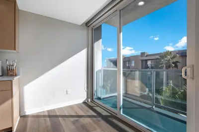 an open kitchen with a large window with a view at Coastal Bliss - Luxe 2BR Retreat in MDR - Venice - SM in Los Angeles
