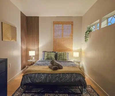 a bedroom with a large bed with two lamps at Brimfield Stay in Los Angeles