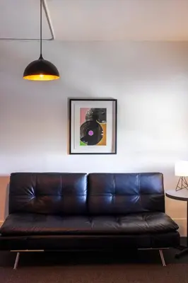 a brown leather couch sitting in a living room at American Hotel in Los Angeles