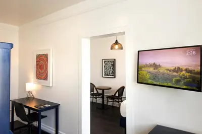 a living room with a flat screen tv on a wall at American Hotel in Los Angeles