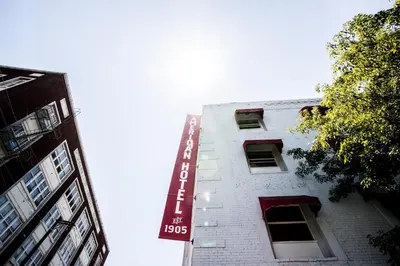 a white building with a sign on the side of it at American Hotel in Los Angeles