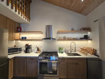 a kitchen with a stove and a sink in it at Modern Lagunita Cabin Near the Lake in Big Bear Lake