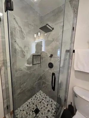 a shower with a glass door in a bathroom at Modern Lagunita Cabin Near the Lake in Big Bear Lake