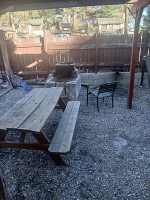 a picnic table and a grill in a yard at Cabin 33, 3 bedroom 2 bath in Big Bear Lake