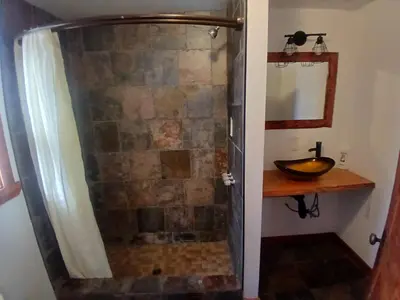 a bathroom with a shower with a sink at Cabin 33, 3 bedroom 2 bath in Big Bear Lake