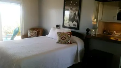 a bedroom with a white bed with two pillows at Hilltop Tavern and Inn in Apple Valley