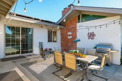 a patio with a table and chairs in front of a house at Luxury Estate with Sparkling Pool & Elegant Amenities in Glendora