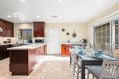 a kitchen with a table and chairs and a kitchen with a counter at Luxury Estate with Sparkling Pool & Elegant Amenities in Glendora
