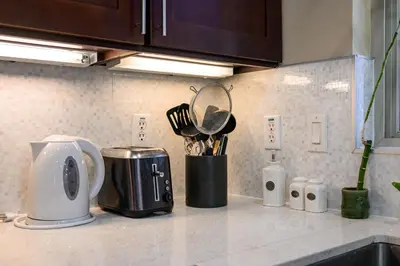 a kitchen counter with a toaster and utensils at Luxury Estate with Sparkling Pool & Elegant Amenities in Glendora