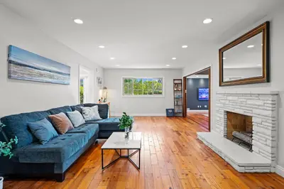 a living room with a blue couch and a fireplace at Luxury Estate with Sparkling Pool & Elegant Amenities in Glendora