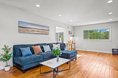 a living room with a blue couch and a table at Luxury Estate with Sparkling Pool & Elegant Amenities in Glendora