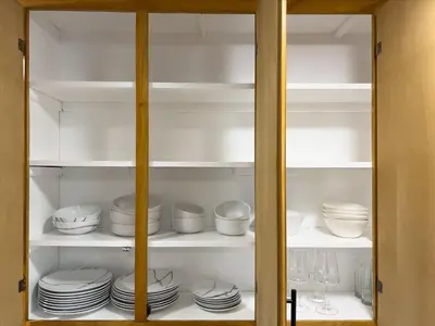 a cabinet filled with plates and bowls and dishes at Modern 4 bedroom in San Fernando in San Fernando