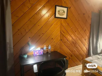a room with a wooden wall with a table with a lamp at \u72ec\u5177\u4e00\u683c\u7684\u623f\u95f4 in West Covina
