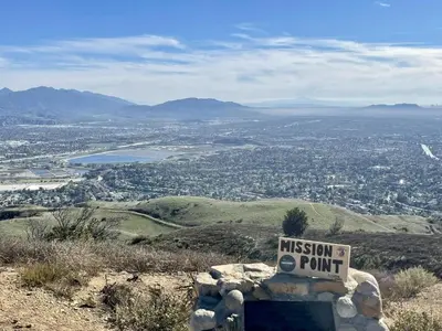 a sign sitting on top of a hill overlooking a city at Adorable 4 bedroom home with Pool & more in Los Angeles