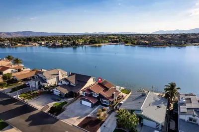 an aerial view of a large lake with houses at The Lakefront Oasis in Victorville