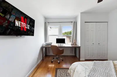 a bedroom with a bed and a desk with a computer at Cosy 3BD by Santa Monica - Beach & Airport 10 min away in Los Angeles