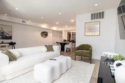 a white living room with a white couch and chairs at Exquisite Haven with Patio Sleeps 4 in Los Angeles
