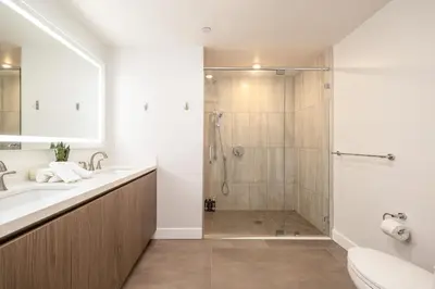 a bathroom with a shower and a toilet and a sink at Exquisite Haven with Patio Sleeps 4 in Los Angeles