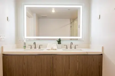 a bathroom with two sinks and a large mirror at Exquisite Haven with Patio Sleeps 4 in Los Angeles
