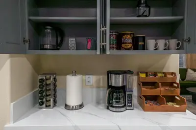 a kitchen counter top with a coffee maker on it at Disneyland Retreat Fun Family Unit w Game Room, King Beds & EV Friendly - Sleeps up to 14 in Midway City