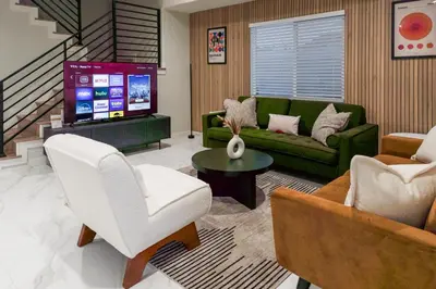 a living room with a couch and a tv at Disneyland Retreat Fun Family Unit w Game Room, King Beds & EV Friendly - Sleeps up to 14 in Midway City
