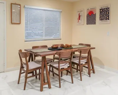 a dining room with a wooden table and chairs at Disneyland Retreat Fun Family Unit w Game Room, King Beds & EV Friendly - Sleeps up to 14 in Midway City