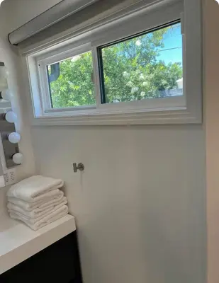 a window in a bathroom with towels on a counter at Charming one bed one bath privet studio in Tarzana