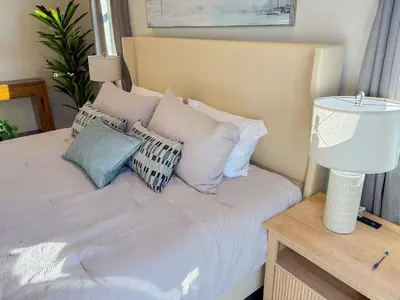 a bedroom with a bed with pillows and a lamp at Central North Hollywood Home in Los Angeles