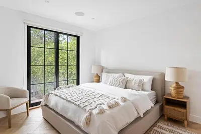 a white bedroom with a large bed and a window at Mediterranean Dream Villa Oasis in Los Angeles