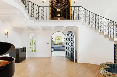 a living room with a staircase and a door with a car at Mediterranean Dream Villa Oasis in Los Angeles