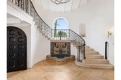 a staircase in a white house with a stair case at Mediterranean Dream Villa Oasis in Los Angeles
