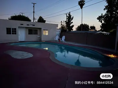 a swimming pool in a yard with a house at \u6e29\u99a8\u7684\u5c0f\u623f\u95f4 in West Covina