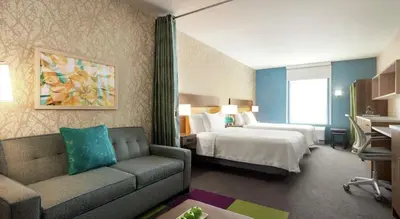 a hotel room with a bed and a couch at Home2 Suites By Hilton Camarillo in Camarillo