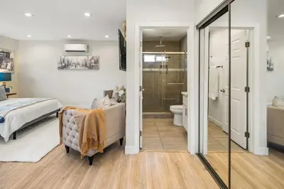 a bedroom with a bed and a bathroom with a shower at Cute House in West Valley Area Heliport