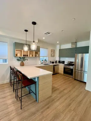 a large kitchen with a large island in the middle at New Luxe 3B 3Bath Townhouse in Sherman Oaks